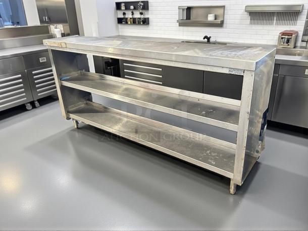 All stainless steel custom-made table with two shelves, sturdy construction, in good condition. Suitable for professional kitchens.