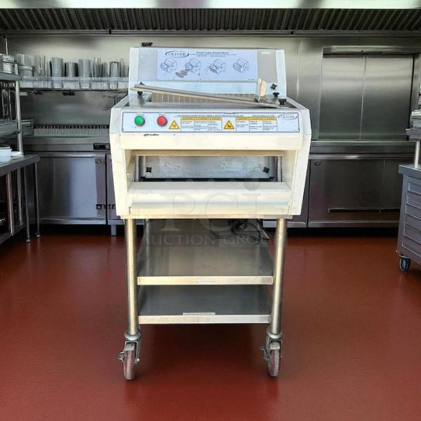 Oliver 732-N bread slicer in great condition, with bagging scoop, 115v, tested and working, stainless steel frame with wheels.