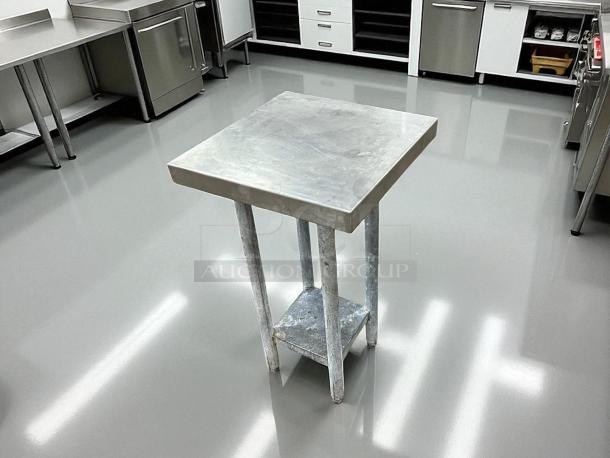 Stainless steel worktop table, excellent condition, square top, sturdy metal legs, ideal for kitchen or industrial use.