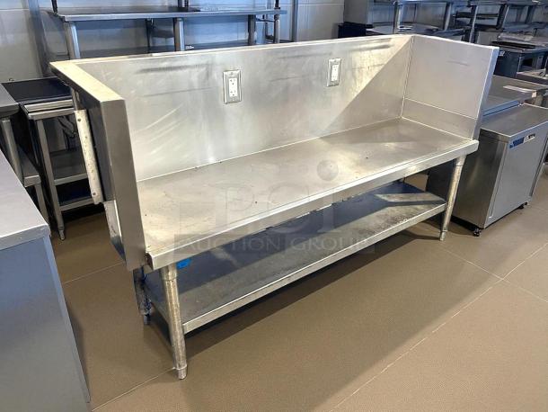 Custom stainless steel table with two built-in outlets, spacious top, and lower shelf. Durable, ideal for kitchens.