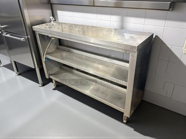 All stainless steel custom-made table with two shelves, sturdy construction, excellent condition, ideal for kitchen use.