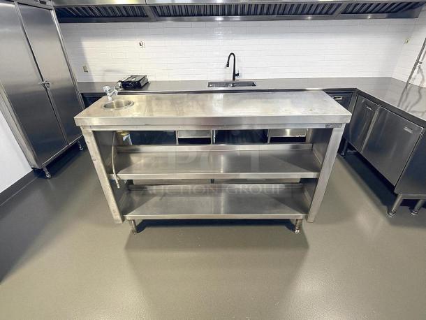 All stainless steel custom-made table with shelves, sink, and sturdy frame. Excellent condition, ideal for commercial use.
