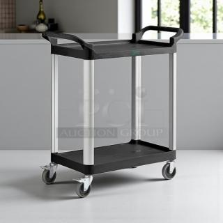 Brand new Choice black utility cart, 32" x 16", with two shelves and swivel casters, ideal for bussing tasks.
