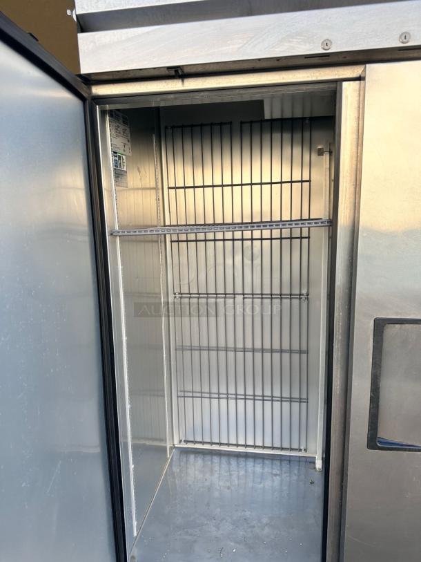 True T-72F-HC 3-door commercial freezer, excellent condition, interior view, metal shelving, label inside, 115V, fully tested.