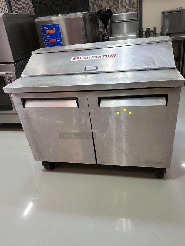 Turbo Air TST-48SD 48" refrigerated salad prep table in outstanding condition, labeled "Salad Station," fully tested and working.