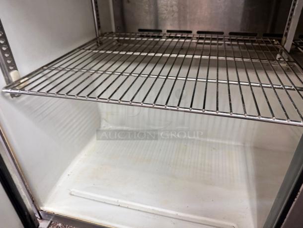 Turbo Air TST-48SD refrigerated salad prep table interior, featuring a stainless steel wire shelf, in outstanding condition.
