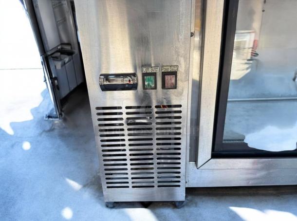 Avantco UBB-48G 48" Glass Door Back Bar Refrigerator in great condition, with visible light and power switches.