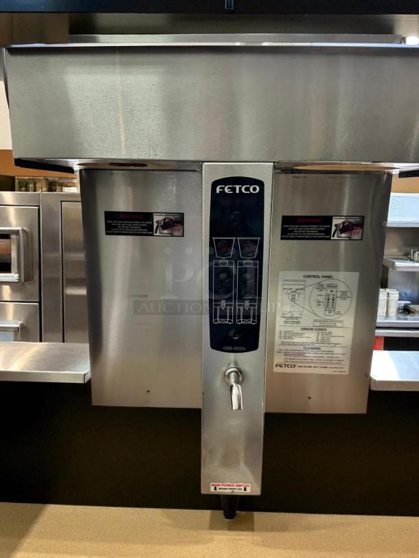 Fetco CBS-2032e dual station coffee brewer in outstanding condition, stainless steel, fully tested, 220-240V, control panel visible.
