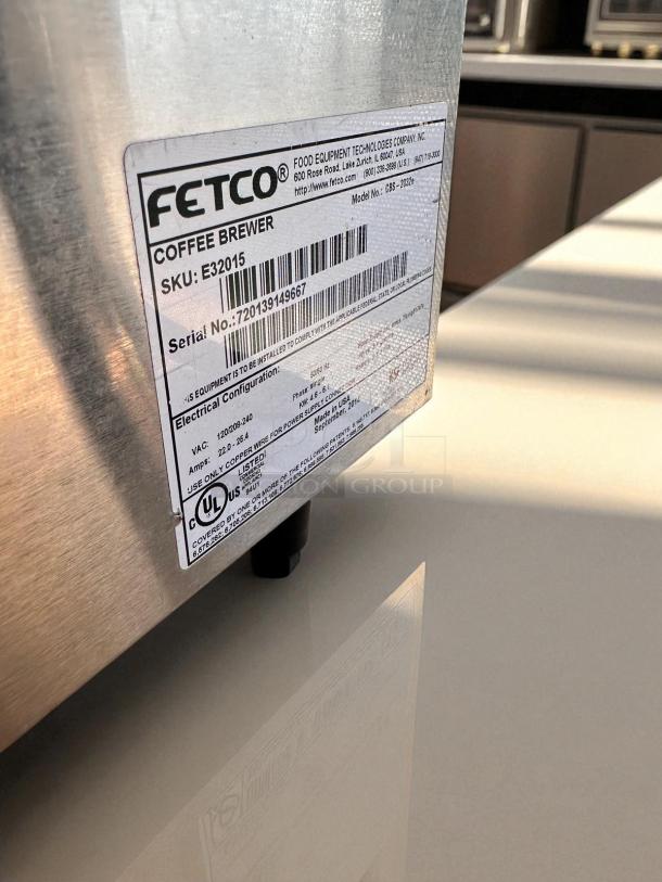 "Fetco CBS-2032e coffee brewer label showing model, serial number, SKU, and 220-240V electrical specs, outstanding condition."