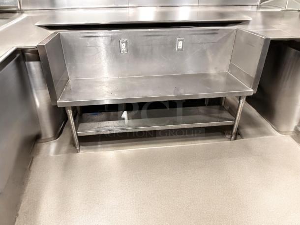 Stainless steel commercial work table, 65" x 24" x 40", with undershelf and two electrical outlets. Great condition.