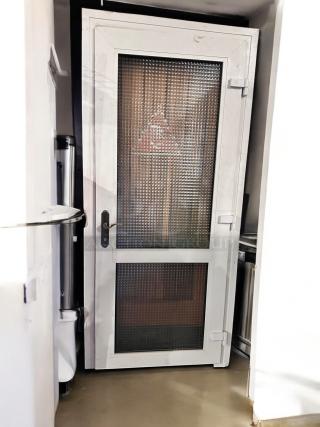 White metal frame door with dual textured glass panels, 36" x 83", in great condition. Features secure locking mechanism.
