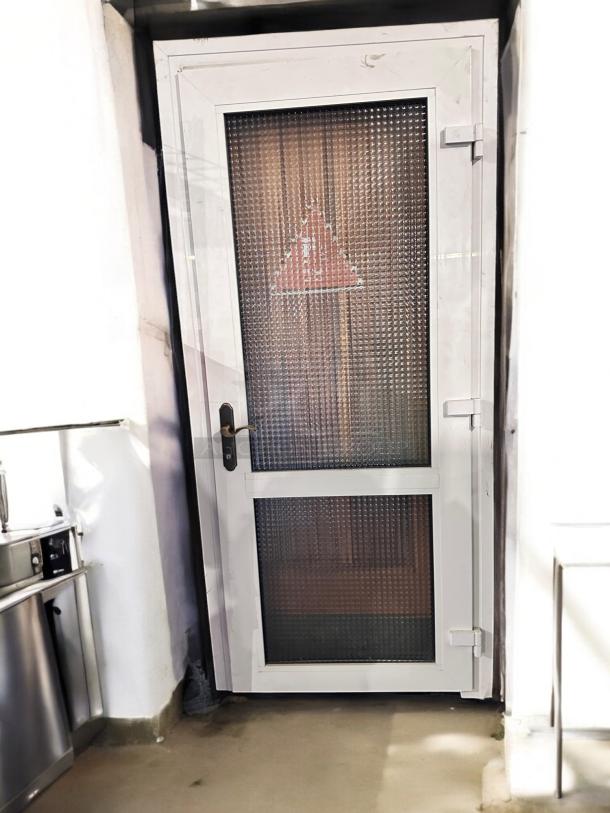 White metal frame door, 36" x 83", with dual textured glass panels. Great condition, tested and working.