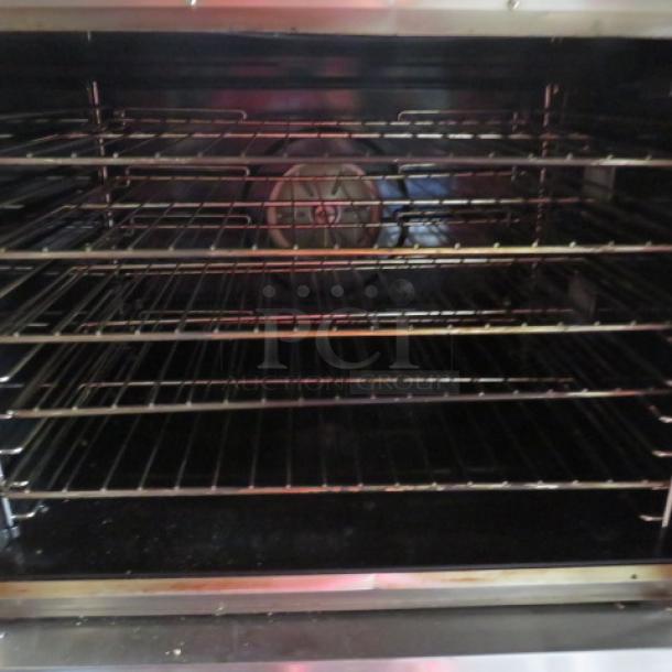 Blodgett BOD-100-E electric convection oven, full size, 38x37x57.5 in, used condition, multiple shelves shown inside.