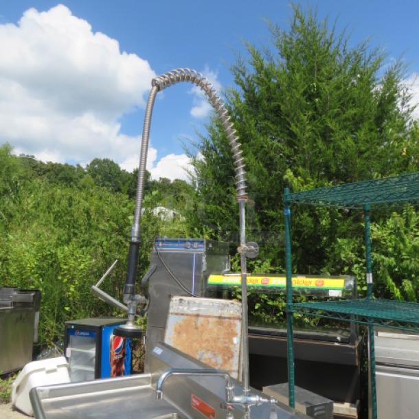 Steelton 3 Compartment Sink with R/L Drain Boards and Faucet Hose Sprayer, Model 522CB316201B, 83x27x44, outdoor setting.