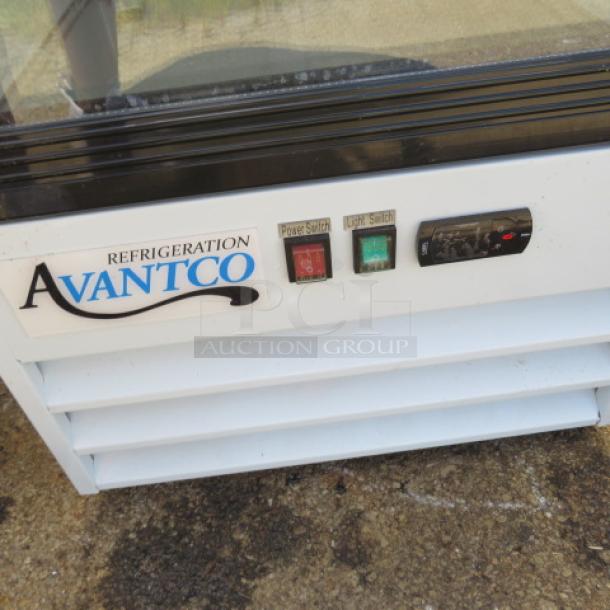 Avantco glass display cooler with 4 racks, Model 178GDC10HCW, 115V, 21"x24"x62.5", visible power and light switches.