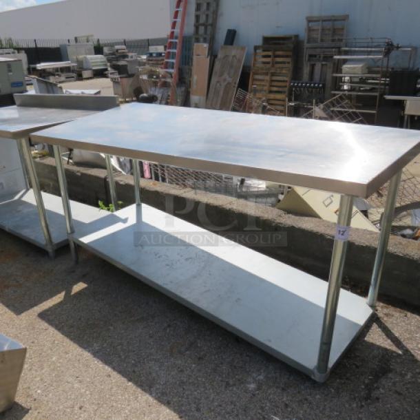 Stainless steel table with under shelf, 72x30x34 inches, excellent condition, ideal for kitchen or workspace use.