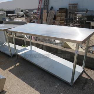 Stainless steel table with under shelf, 72x30x34 inches, excellent condition, ideal for kitchen or workspace use.