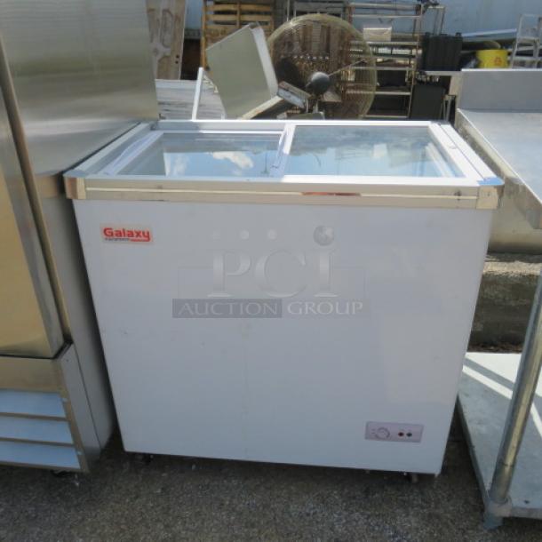 Galaxy Flat Top Display Freezer, Model 177ICFF7HC, 115V, 34x21.5x34 inches, on casters, working condition.