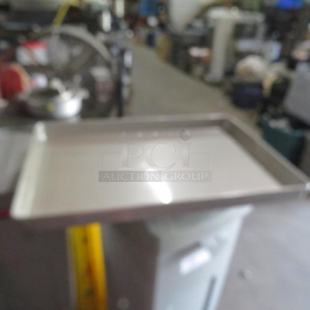 Full-size baking pan, 2.5 inches deep, stainless steel, used condition, no visible labels.