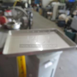 Full-size baking pan, 2.5 inches deep, stainless steel, used condition, no visible labels.