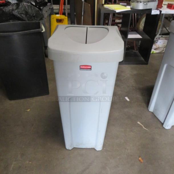 Rubbermaid 23 Gallon Trash Can with flip lid, gray, good condition, visible brand logo on front.