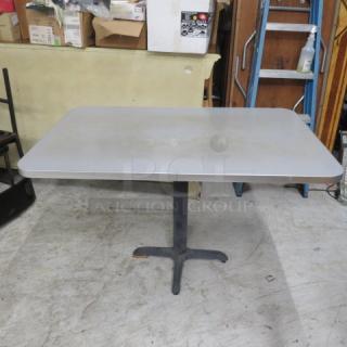 Gray laminate tabletop on a pedestal base, dimensions 48x30x30 inches. Sturdy, ideal for office or dining use.