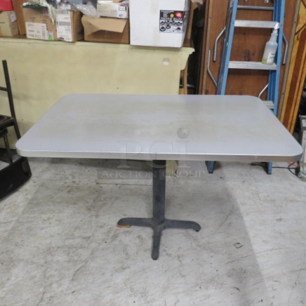 Gray laminate table top on pedestal base, measuring 48x30x30 inches. Used condition, ideal for home or office use.