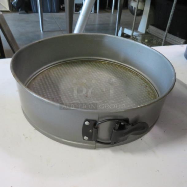 10.5-inch springform bake pan with latch, metal construction, used condition, removable textured base.