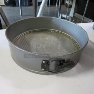 10.5-inch springform bake pan with latch, metal construction, used condition, removable textured base.