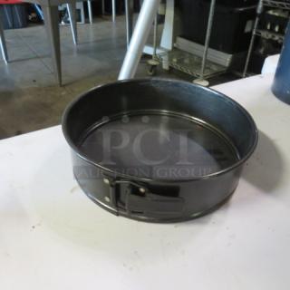 9.5-inch spring form bake pan, black finish, excellent condition, secure latch for easy baking release.