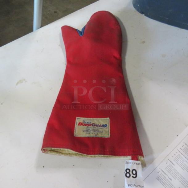 One Tucker Burn Guard Glove, red, insulated, safety mitt with visible label, gently used condition.