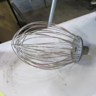 A stainless steel whip attachment, industrial size, in used condition, ideal for commercial mixers.