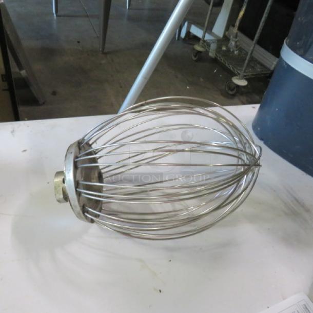Stainless steel whisk with wire design, moderate wear, suitable for heavy-duty mixing tasks.