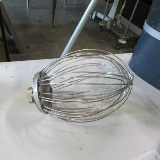 Stainless steel whisk with wire design, moderate wear, suitable for heavy-duty mixing tasks.