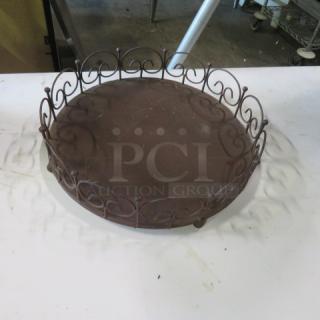 12-inch brown metal bakery display stand with ornate scroll design. Good condition, ideal for showcasing baked goods.