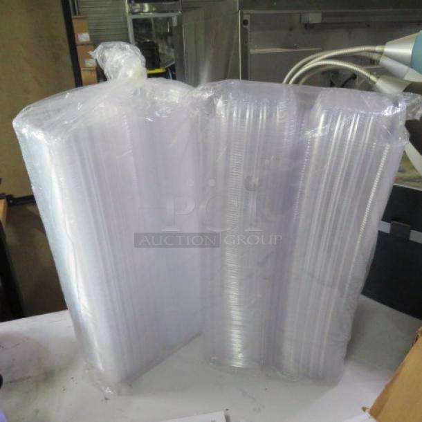 Plastic hinged lid sandwich to-go boxes, wrapped in transparent plastic. New condition, bulk lot packaging.