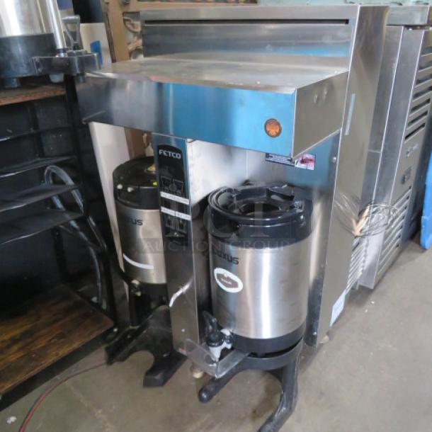 Fetco CBS-2052E coffee brewer with 2 filter baskets, 2 satellites on stand; untested condition, stainless steel finish.