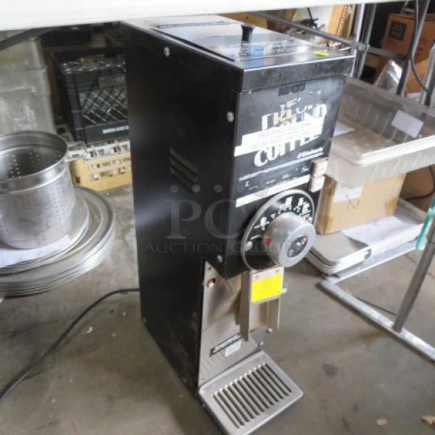 Grindmaster Model 875 coffee grinder, 115V, black, with dial controls. Measures 7x15x27. Some wear visible; includes labels.