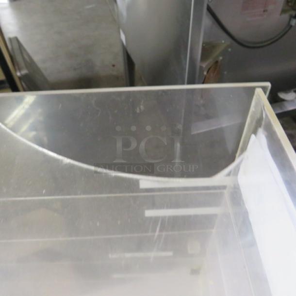 Clear poly bakery display case with one door and five shelves. Features a broken top edge. Dimensions: 19x13.5x20 inches.