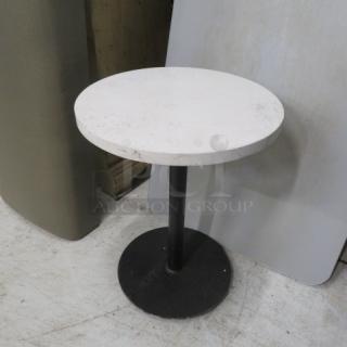 Round marble top table, 20x26 inches, with black metal pedestal base; minor surface wear visible.