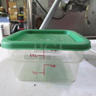 Transparent 2-quart food storage container with green lid, marked with red measurement lines. In good condition.