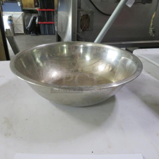 13-inch stainless steel mixing bowl, gently used, reflecting light. No visible markings or labels, sturdy design.