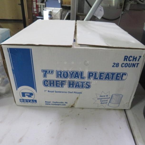 Box of 7-inch Royal Pleated Chef Hats, 28 count, featuring new and improved sweatband; packaging shows minor wear.