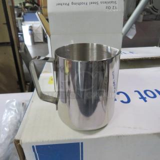 12oz stainless steel frothing pitcher, new condition, with sturdy handle, polished finish, placed on packaging box.