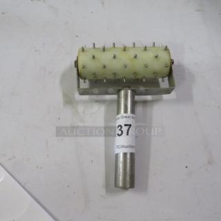 One Roller Docker with metal pins, stainless steel handle, and a label marked "37 PCI Auctions." Good condition.
