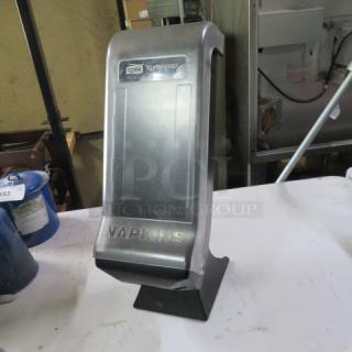 Tork Tabletop Xpressnap Napkin Dispenser, silver, used condition, visible Tork logo and "NAPKINS" label.