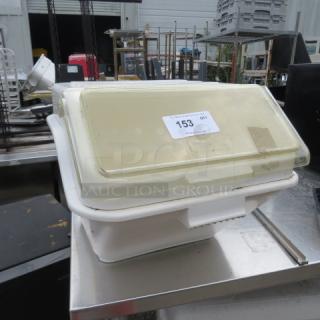 Winco Ingredient Bin with translucent lid, visible wear, and numbered tag 153, placed on a metal surface.