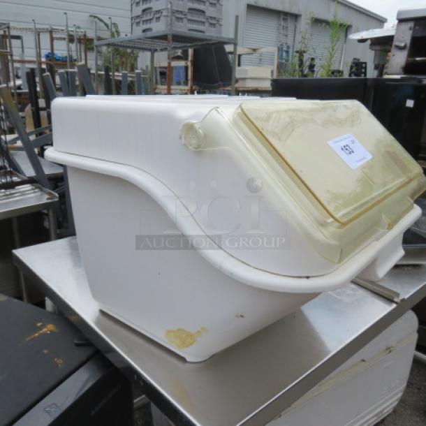 White Winco ingredient bin with a yellow-tinted flip lid. Visible sticker tag. Used condition with noticeable wear.