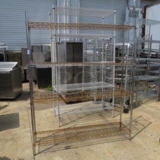 Metro shelf unit with 4 wire shelves, 60x14x75 inches. Some rust visible. Ideal for storage, industrial style.
