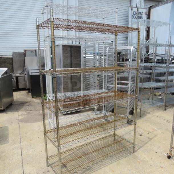 Metro shelf unit with five shelves, 48x18x72 inches. Wire construction, used condition, visible rust on shelves.